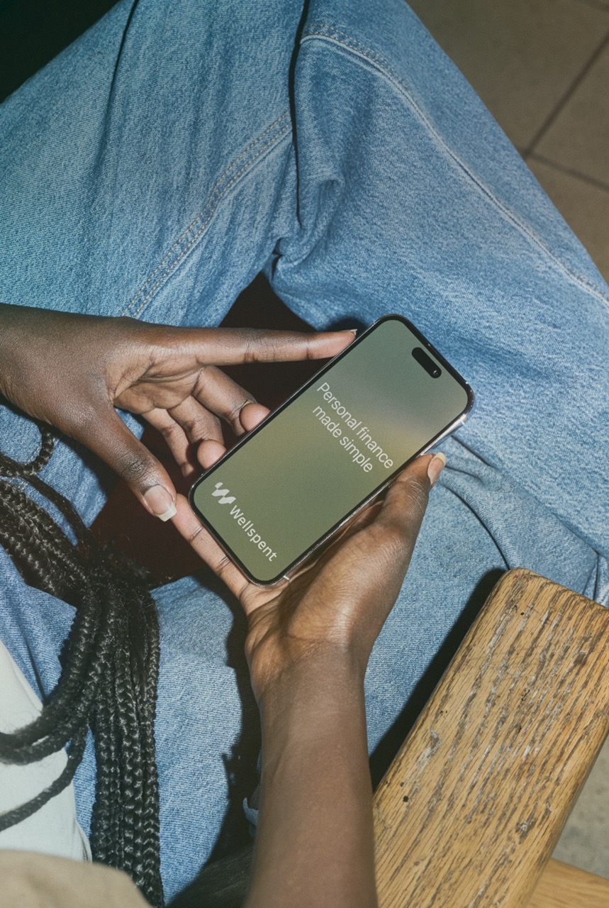 Person tracking expenses with Wellspent app on iPhone